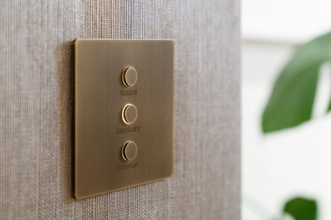 A Lutron Alisse keypad with a Natural, Sanctuary, and Entertain customized backlit press button 