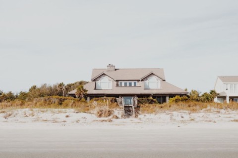 Photo of a beach house taken from the shoreline.