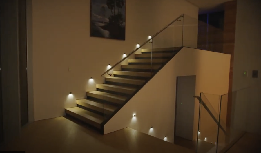 Image of luxury home’s staircase with automated Lutron smart lighting