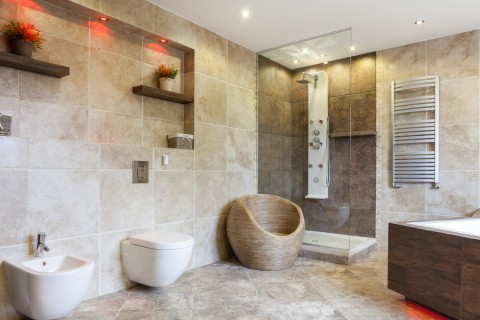Photo of a bathroom with gorgeous lighting, including red recessed LEDs that highlight shelving. 