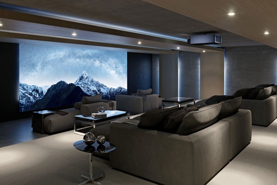 A home theater with a large movie screen, Sony projector, and chaise lounges.