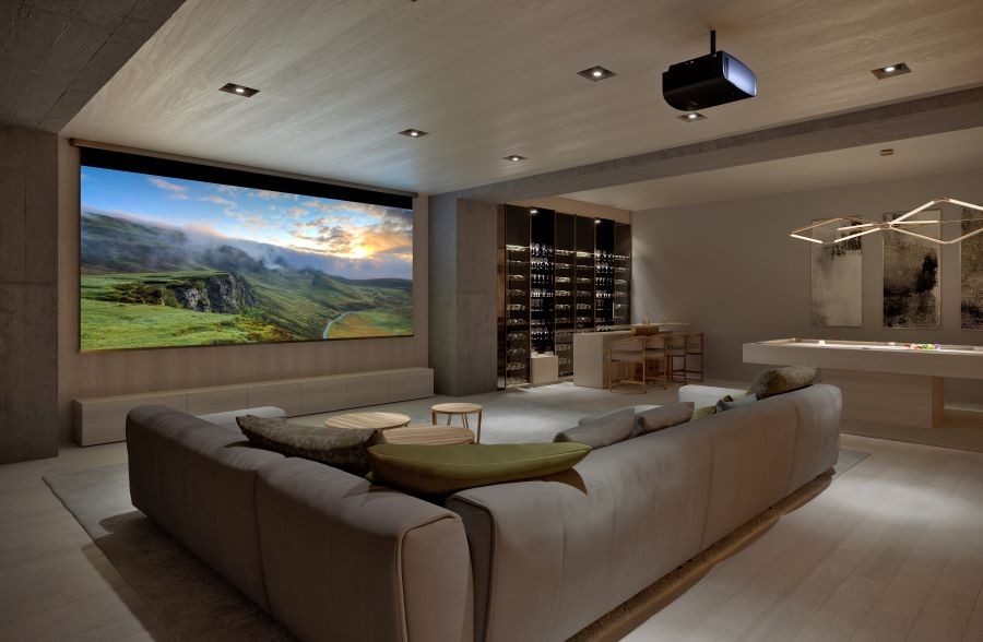 A media room with a large screen, Sony projector, sectional, wine bar, and pool table.