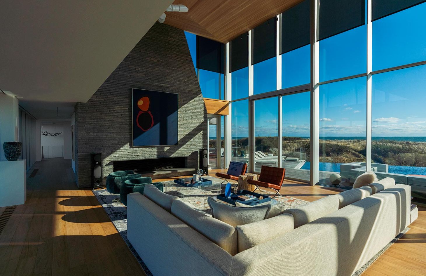 Living Room with modern artwork in stone wall and open shades