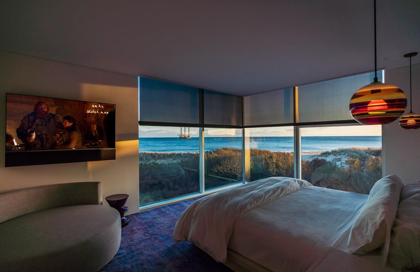 Guest bedroom with panoramic water view and TV